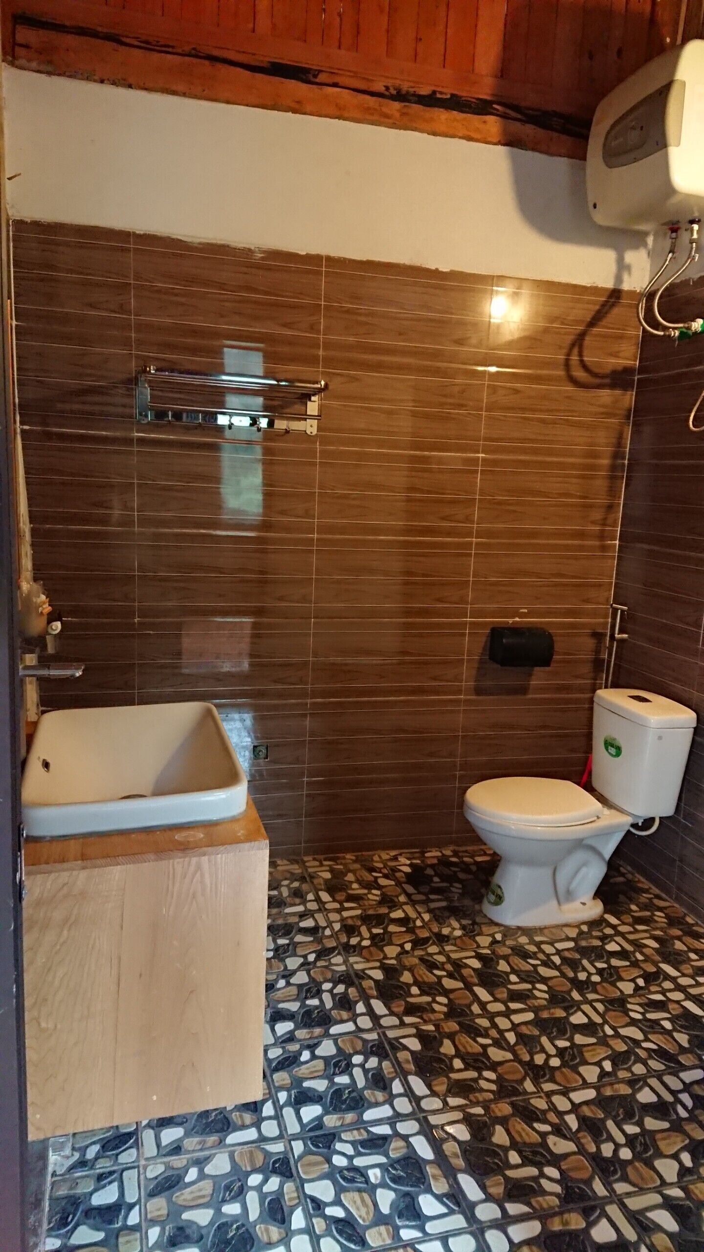 A bathroom with a bathtub, toilet, and a shower area.