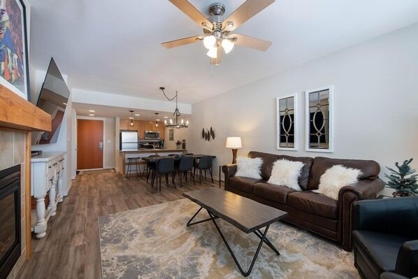 Relax in this stylish living room with a comfortable sofa, coffee table, and dining area.
