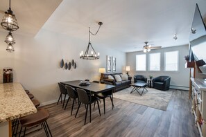 Relax in this spacious living area with a dining table, sofa, and coffee table.