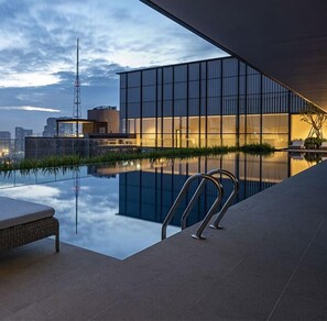 Outdoor pool, open 6:00 AM to 10:00 PM, sun loungers, lifeguards on site - The Rixx MarQ (Ho Chi Minh City)