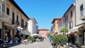 A narrow street lined with buildings, some with balconies and outdoor seating, suggesting a pedestrian-friendly area. - Villa Glicine by Interhome (Forte dei Marmi)