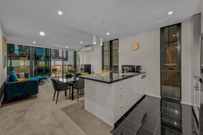 Enjoy a city view from the open-plan living area with a comfortable seating space and dining table.