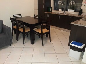 Cozy living space with a dining area, sofa, and kitchenette.