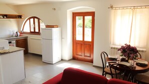 Enjoy meals in the kitchen with a dining table near a window, offering a view of the outdoors.