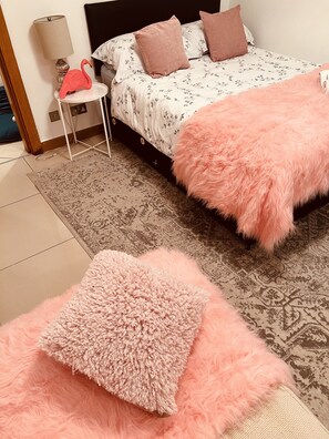 Relax in a beautifully appointed bedroom with a plush bed, nightstand, and cozy throw blanket.
