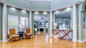 A spacious living room with a fireplace, comfortable seating, and a television. - Salty Moose | 2BD Close To Whitecap Beach | Pool (Corpus Christi)
