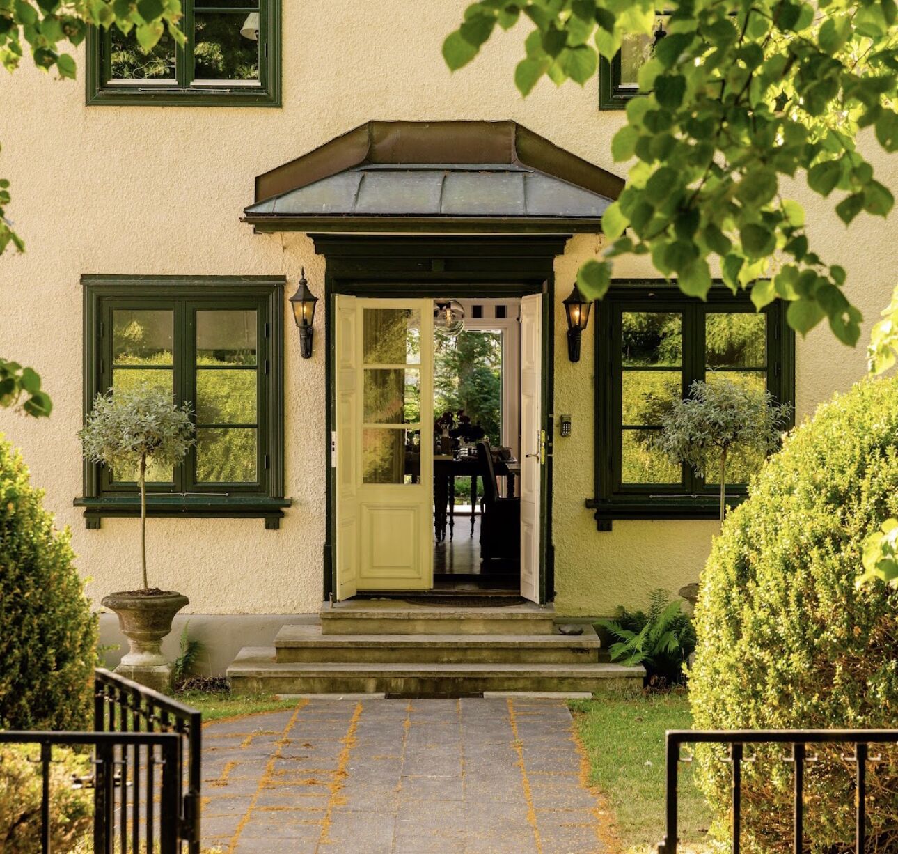 A house with a front door, two windows, and a small porch.