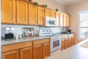 Enjoy cooking in this well-equipped kitchen with a microwave, coffee maker, and stove.