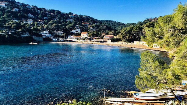 A coastal town with clear blue waters, houses on a hillside, and boats docked near the shore. - Beach house (La Seyne-sur-Mer)