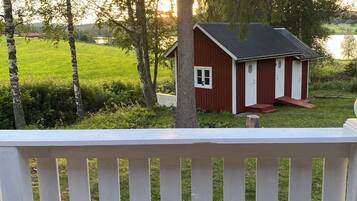 Guests can enjoy the serene surroundings from the deck, overlooking a tranquil body of water.