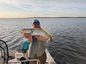A person holding a fish on a boat. - Waterfront Scallop & Fish Spot! Private Dock 2 boats + Ice Machine—Pet Friendly (Perry)