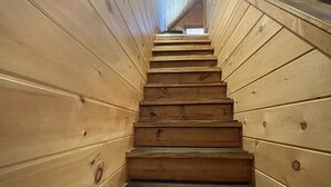 A wooden staircase with a handrail, leading upwards. - Cozy Cabin on the edge of town only 1/2 mile from Current River ! (Van Buren)