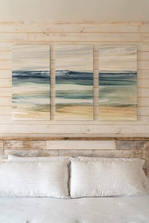 A bedroom with a wooden headboard, a bed with white bedding, and a large abstract painting above the bed. - Rockport Stay: Pool, Deck & Boat Parking Included! (Rockport)
