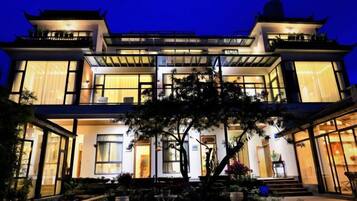 A two-story building with large windows and a traditional architectural style.
