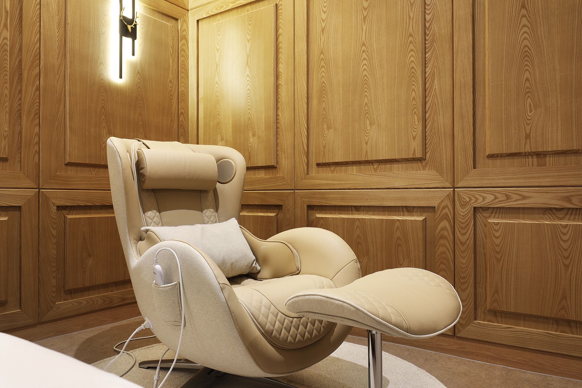 A reclining chair with a massage function in a room with wooden panel walls.