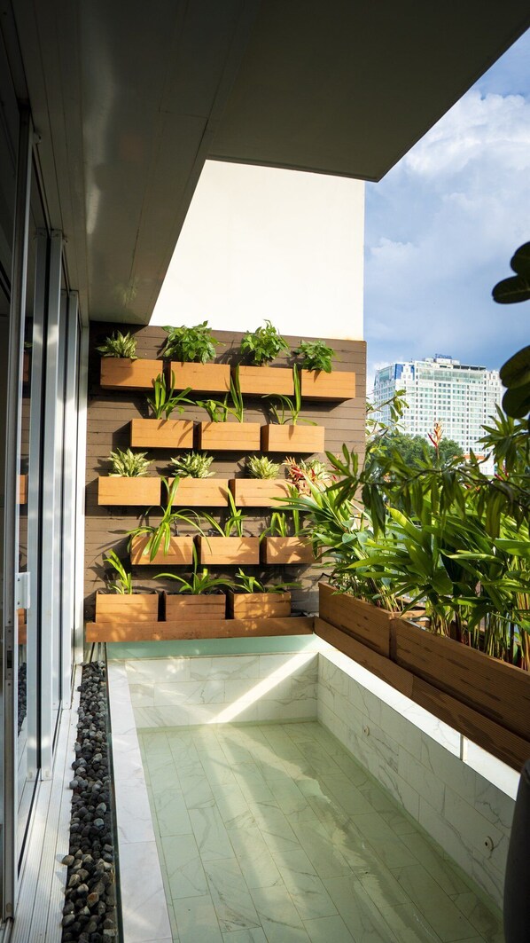A modern balcony with wooden planters and a view of a cityscape.