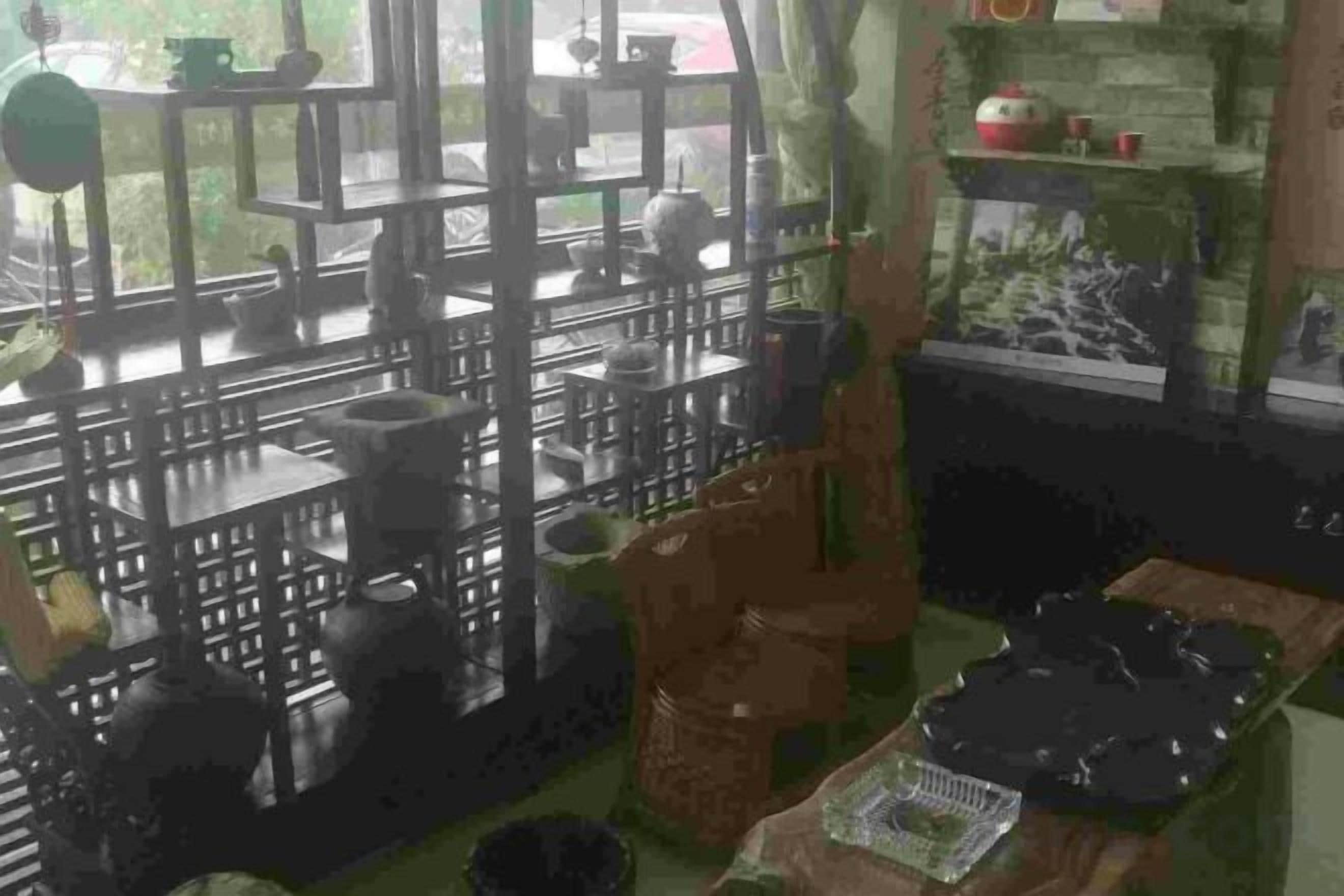 A kitchen with various cooking utensils and appliances, a dining area with a table and chairs, and a view of the outdoors through a window.