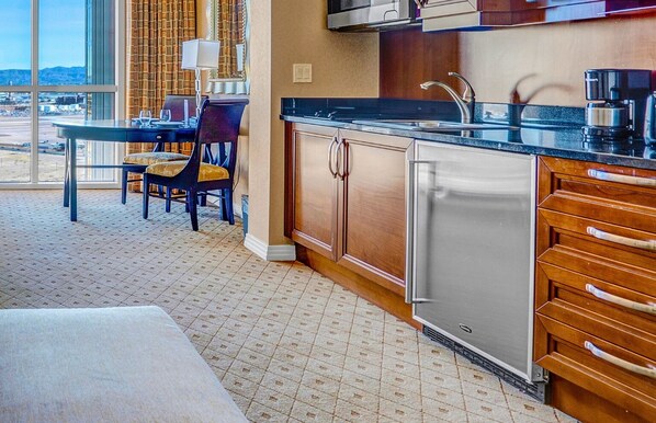 A modern kitchen with a large island, stainless steel appliances, and a view of the airport.