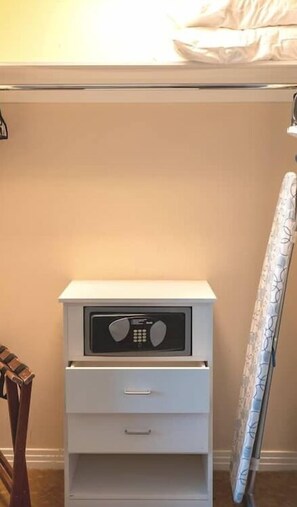A white bedside table with a microwave, a drawer, and a small shelf. - MGM Signature | 32nd Floor 2BR Combo | City View & Balcony | No Resort Fee (LAS VEGAS)