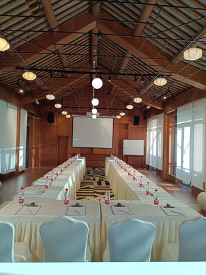 A conference room with a long table, chairs, and a projector screen. - Blossom Hill Hotel Ningbo Hanling (Ningbo)