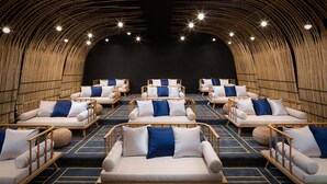 A modern spa with multiple seating areas, each with a cushioned bench and a small round table. - Blossom Hill Hotel Ningbo Hanling (Ningbo)