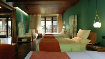 A hotel room with two beds, a nightstand, a lamp, and a view of the outdoors.