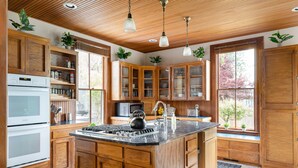 Une cuisine avec des meubles en bois, un îlot central et des appareils électroménagers intégrés.