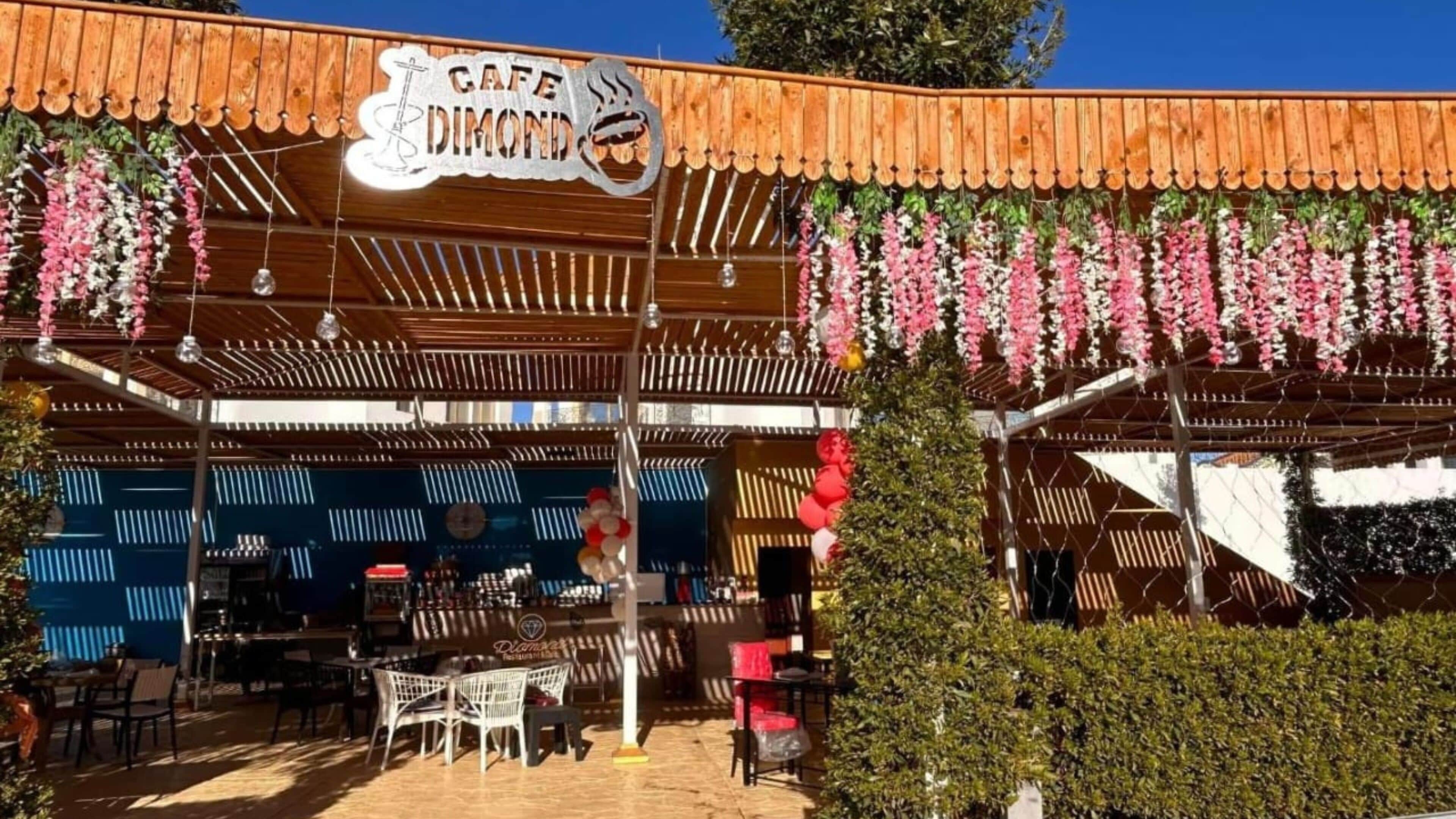 A wooden pergola with a sign reading "Cafe Diamond."