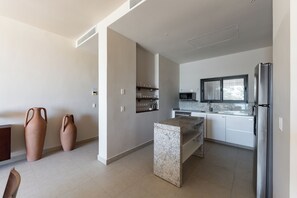 A modern kitchen with a granite countertop, stainless steel appliances, and a built-in oven.