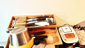 A wooden tray with kitchen utensils, a kettle, and a digital clock displaying 13:06. - Shin-osaka 1109 (Osaka)