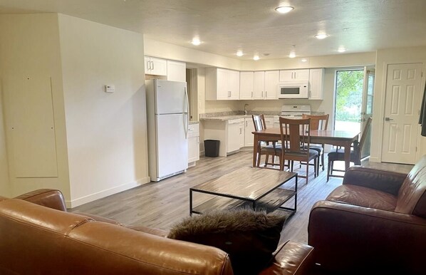 A compact living space with a kitchen, dining area, and seating area.