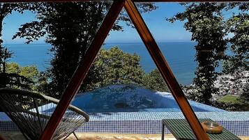 Una piscina al aire libre de temporada, sombrillas