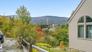 A house with a view of a forested hillside and a mountain in the background. - Fall Line Small Studio - Perfect For Two - On Shuttle Route W/ Amenities G6a 1 Bedroom Condo (Killington)