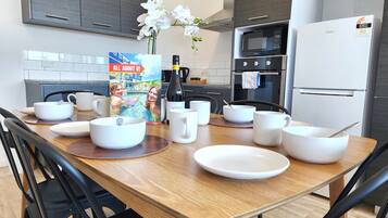 Superior 4 Bedroom Apartment | Private kitchen | Full-sized fridge, microwave, oven, stovetop