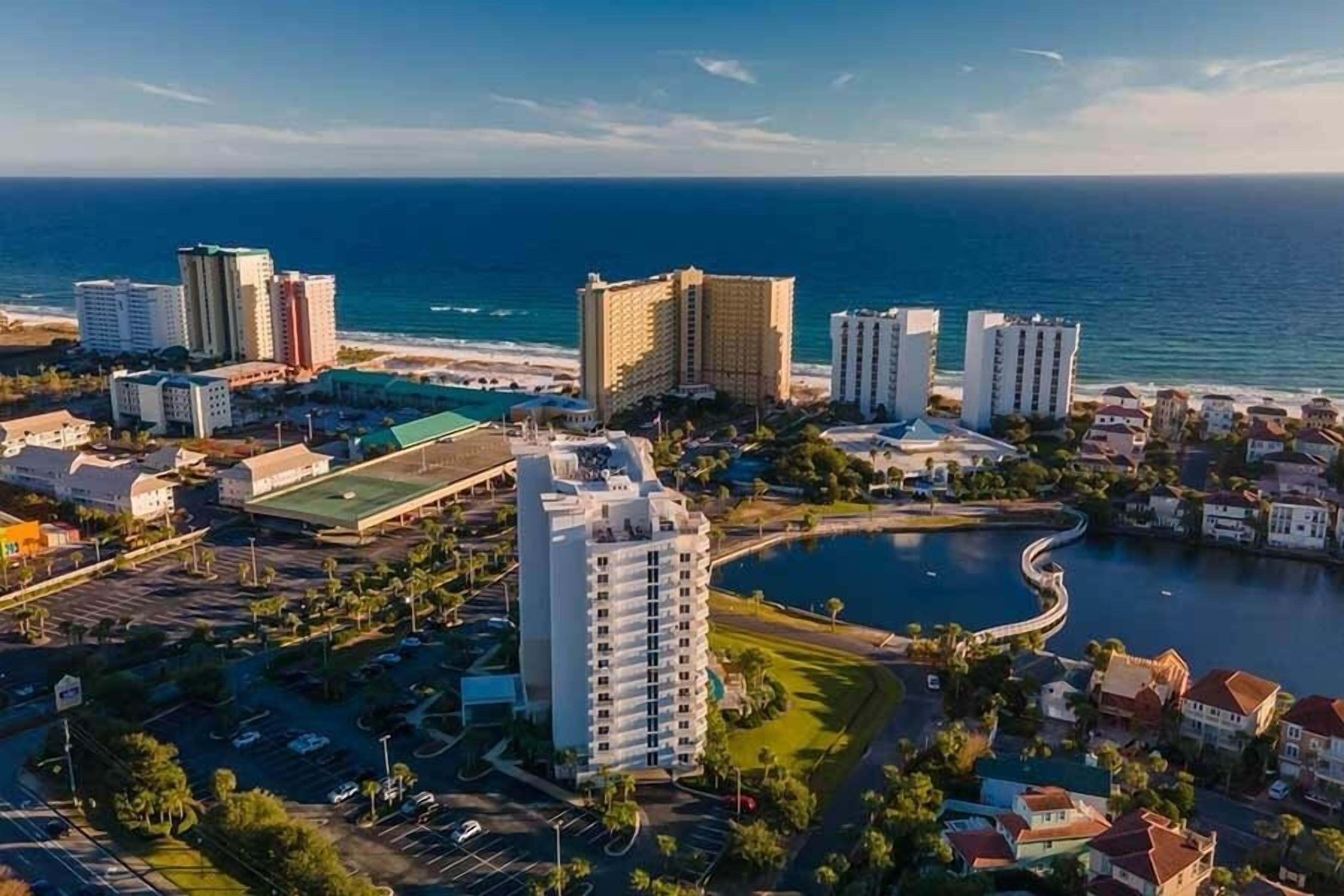 Un paysage urbain côtier avec de hauts immeubles, une marina et une plage.