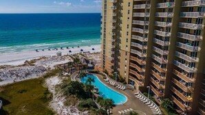 A high-rise hotel with a swimming pool, beach access, and ocean views. - Pelican Beach 1510 1 Bedroom Condo by Pelican Beach Management (Destin)