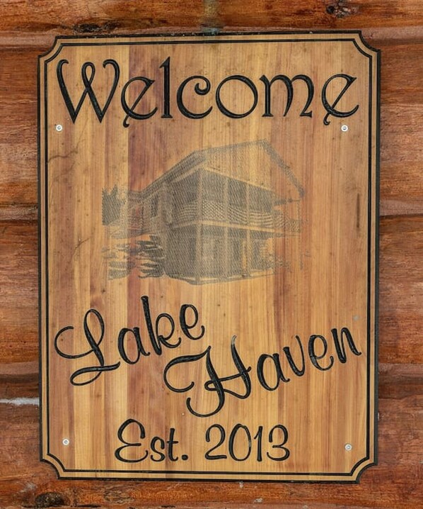 A wooden welcome sign for Lake Haven, established in 2013.