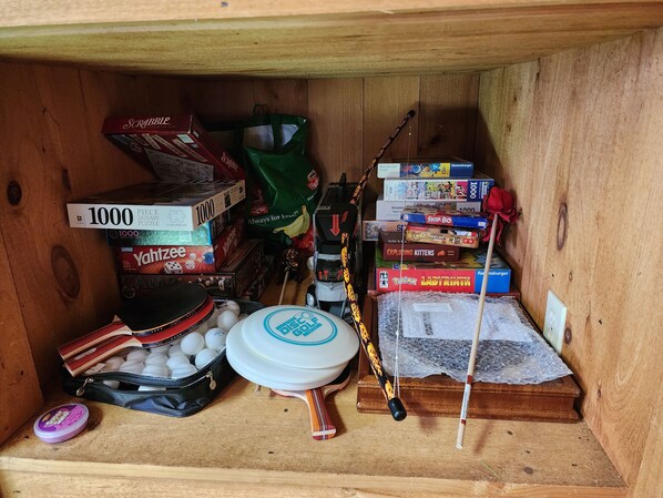 A wooden storage box filled with various board games and puzzles. - Riverfront, family fun, amazing rec room, close to Magic & Okemo (Chester)