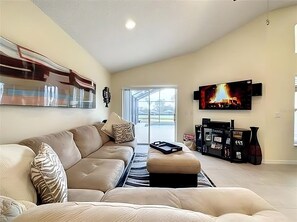 Relax in this stylish living room with a sofa, flat-screen TV, and patio access.