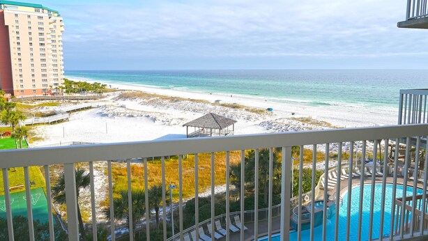 A beachfront hotel with a pool, beach, and ocean view. - Pelican Beach 0614 2 Bedroom Condo by Pelican Beach Management (Destin)