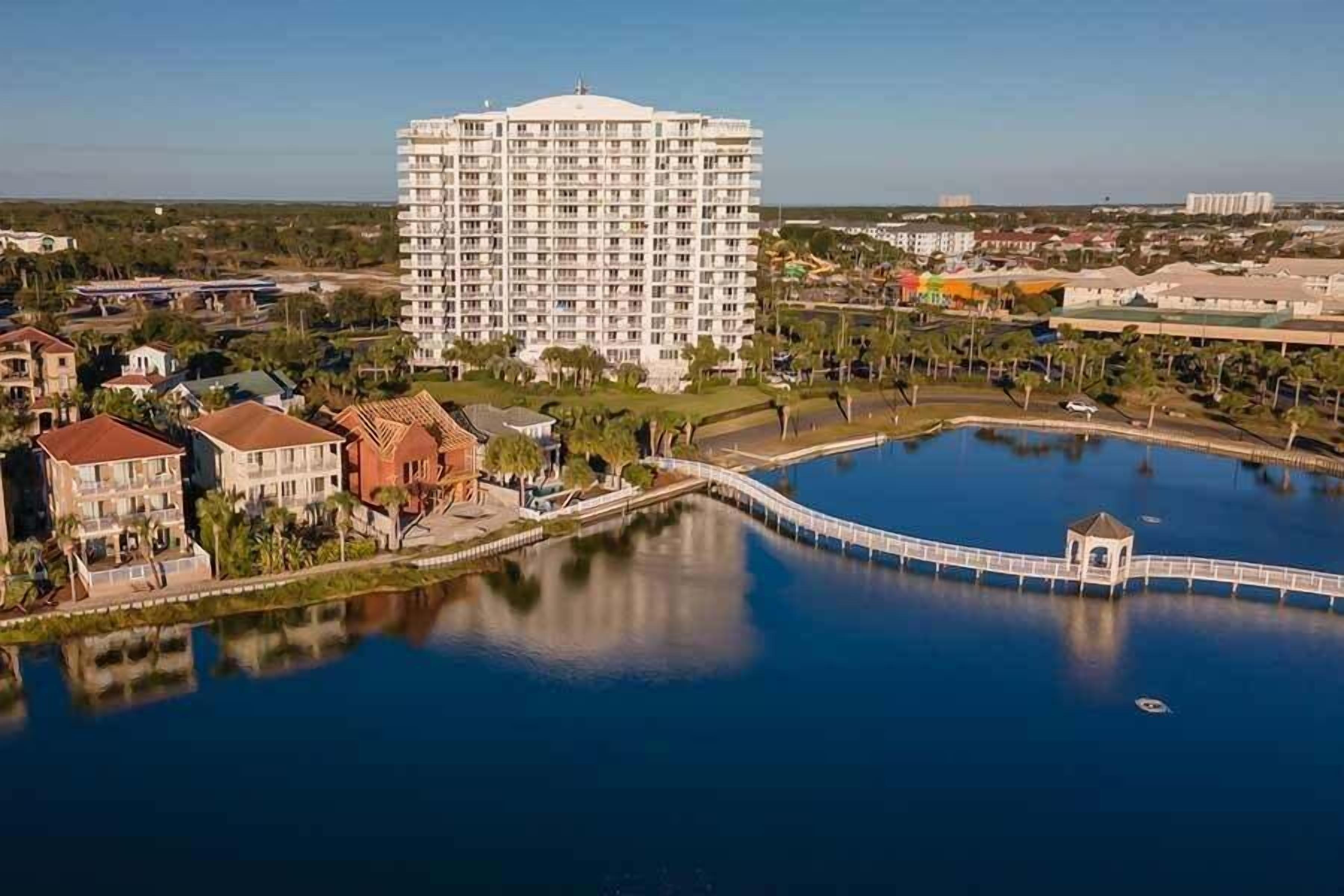 A large hotel with a central courtyard and a swimming pool.