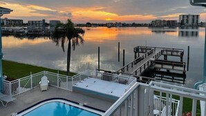 A swimming pool with a view of a marina and sunset. - Mandalay Bay Front Studio (Clearwater)