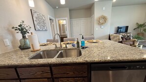 A kitchen with granite countertops, stainless steel appliances, and wooden cabinets. - Oversized 1BR/1BA home near Hospital in Temple, TX  NEW CONSTRUCTION - monthly! (Temple)