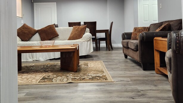 A spacious living room with a sofa, a chair, and a coffee table.