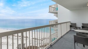 A balcony with a view of the beach and ocean. - Pelican Beach 1716 2 Bedroom Condo by Pelican Beach Management (Destin)