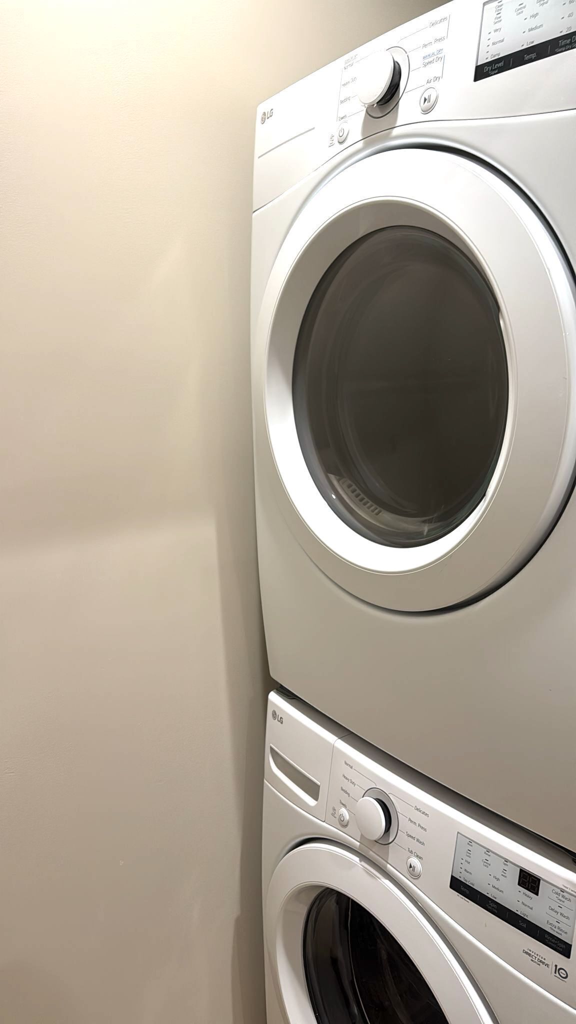 A stacked washer and dryer unit with control panels and a digital display.