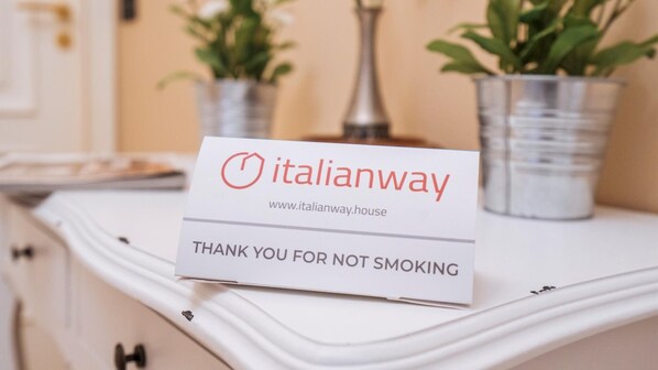 A sign on a white dresser with the text "italianway" and "THANK YOU FOR NOT SMOKING".