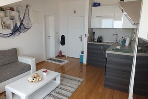 A modern apartment with a living room, kitchenette, and a staircase. - Ferienohnung "silvija" / mit Balkon und Aussicht Aufs Meer (Novalja)