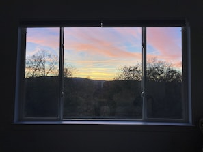 Enjoy breathtaking views of the surrounding landscape from this room's expansive window.