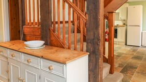 A wooden staircase with a white bowl on a wooden counter. - The Hawthorns (South Molton)